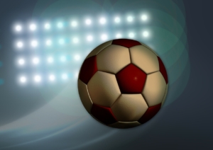 スタジアムの照明とサッカーボール